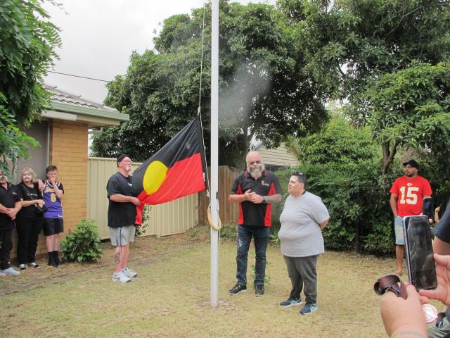 Photo of Aboriginal flag being raised by Uncle Henry Hill & Aunty Alex Osborne at Kirrip on 26 Jan