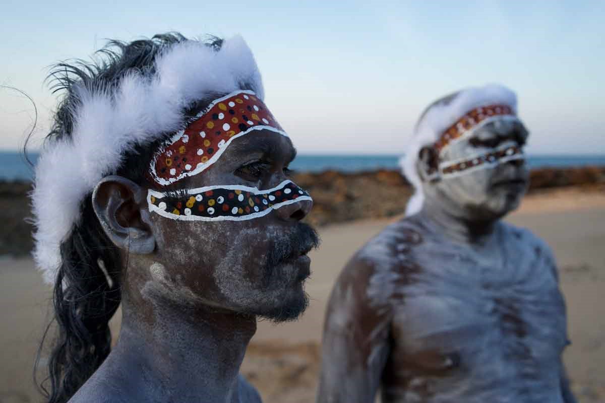 2 Aboriginal men with painted faces on land