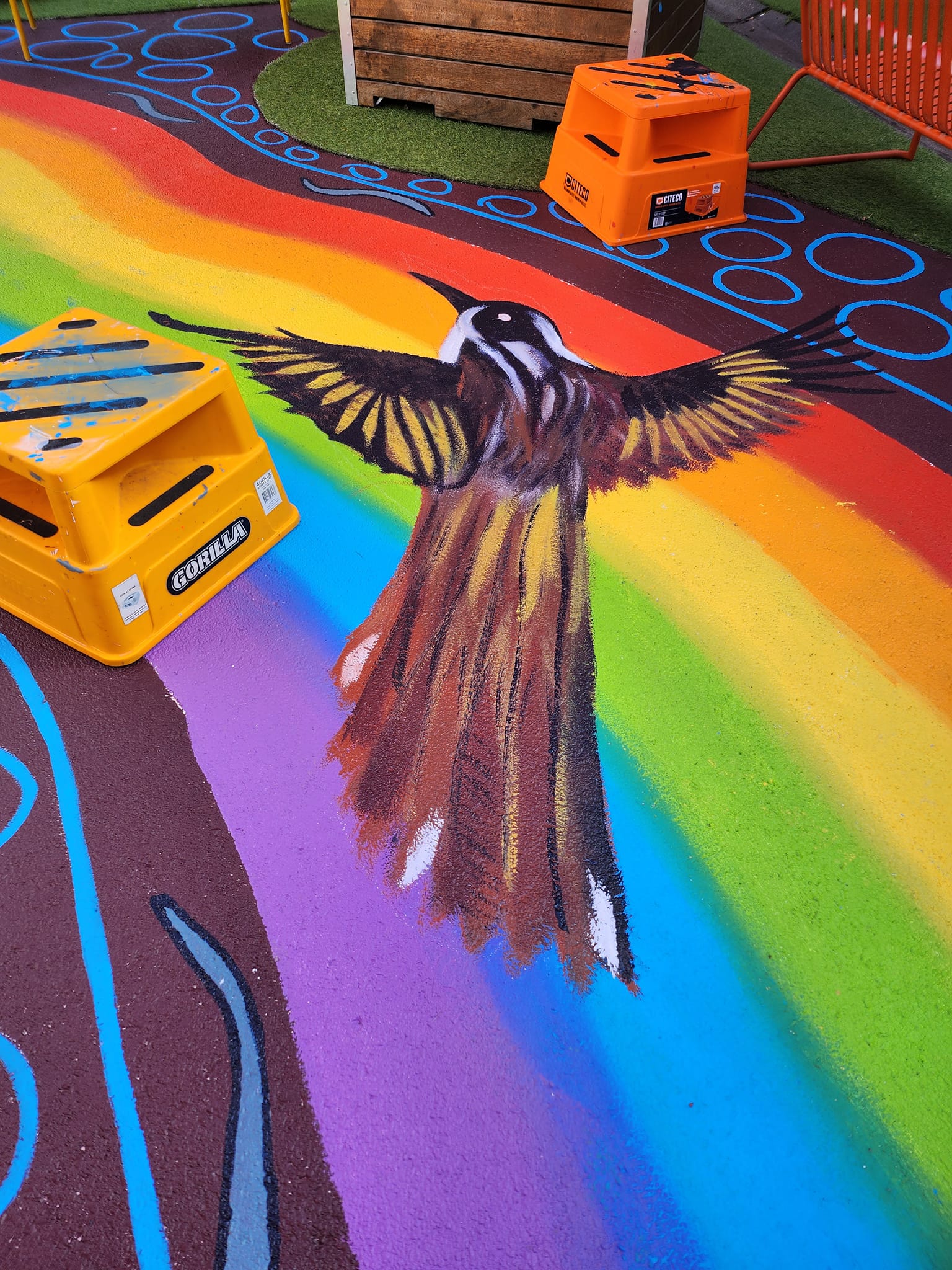 Painting of bird on Rainbow Serpent mural at Point Cook Pup Up Park