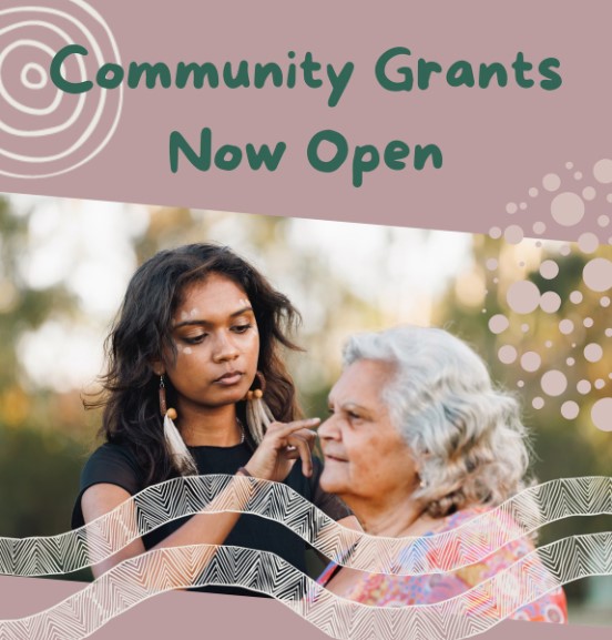 Image of 2 first nations women. One is younger and touching the face of an elder. Decorative design and Text "Community Grants Now Open"