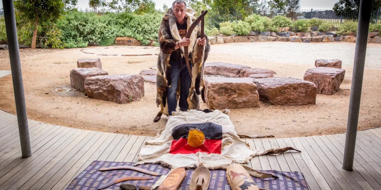Image of Aboriginal Elder Rob Monohan with possum skin cloak with artefacts